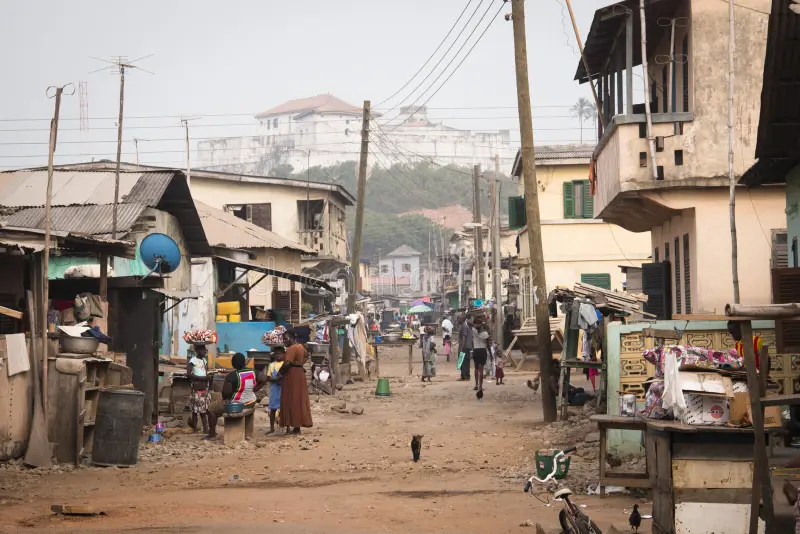 street-elmina-ghana-january-people-sand-streets-town-famous-s-castle-66312649.jpg